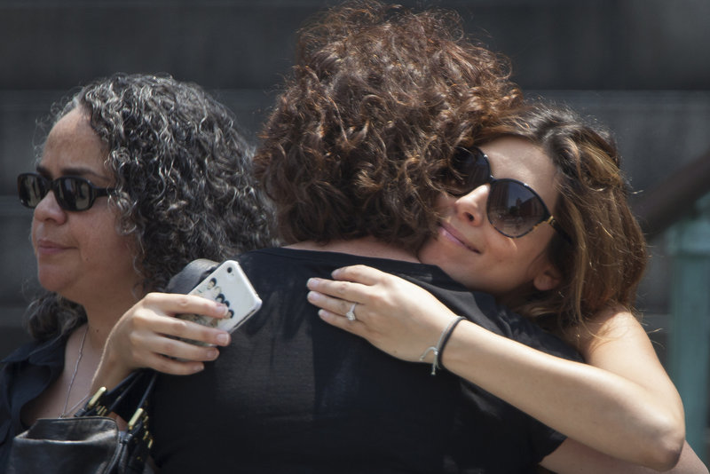 Actress Jamie-Lynn Sigler hugs a woman outside Cathedral Church of Saint John the Divine. Sigler played Gandolfini’s daughter in the show.