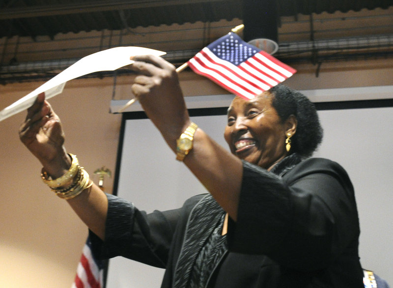 Mariyamu Tausi, a Portland resident originally from the Democratic Republic of the Congo, displays her certificate of citizenship at the Lewiston Regional Technical Center.