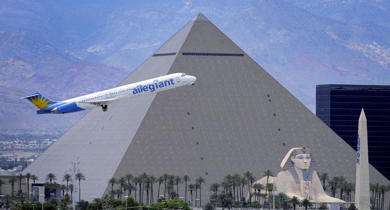 An Allegiant Air jetliner flies by the Luxor Resort & Casino after taking off from McCarran International Airport in Las Vegas. While other U.S. airlines have struggled with the ups and downs of the economy and fuel prices, tiny Allegiant Air has been profitable for 10 straight years.