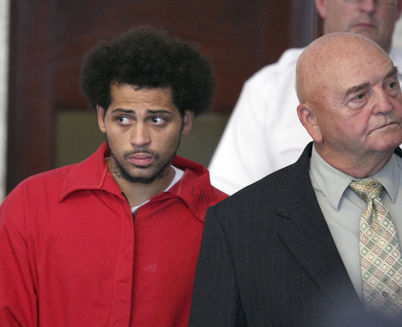 Carlos Ortiz, left, enters Attleboro District Court with attorney John Connors for his arraignment on a gun charge Friday. Ortiz was arrested Wednesday.