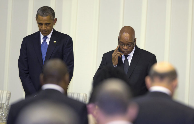 President Obama observes a moment of silence for Nelson Mandela on Saturday at a dinner in Pretoria.