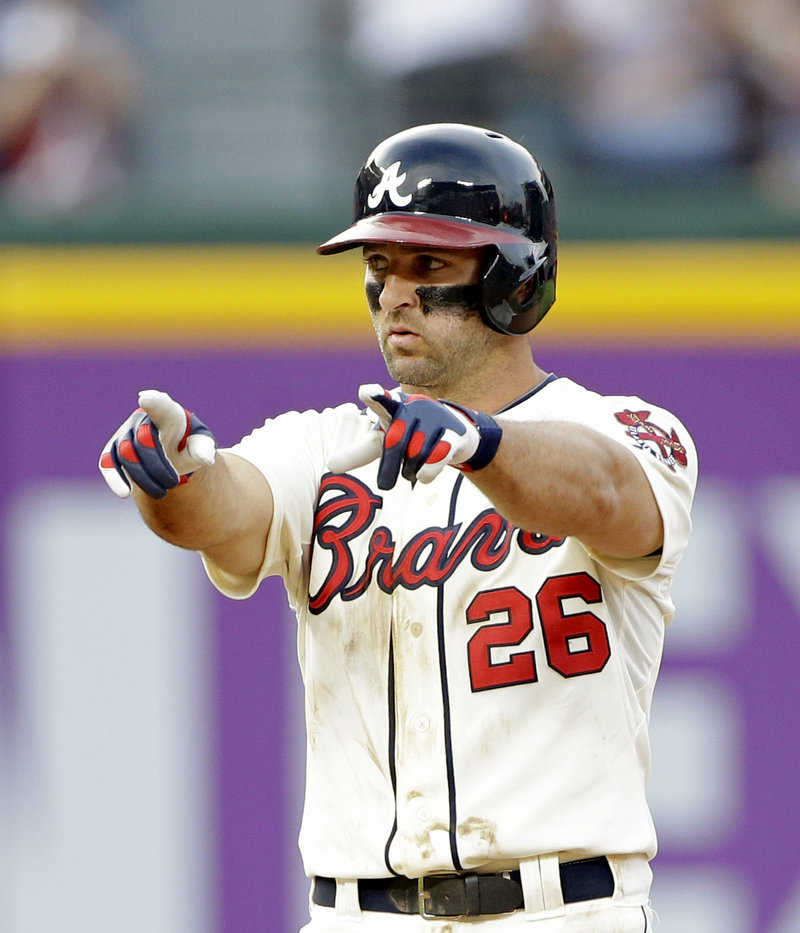 Atlanta’s Dan Uggla reacts after stroking an RBI double in the eighth inning of the Braves’ 11-5 victory over the Arizona Diamondbacks on Saturday.