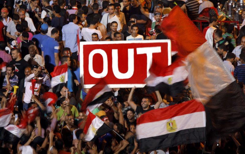 Egyptian protesters hold a banner in Tahrir Square during a demonstration against Egypt's Islamist President Mohammed Morsi in Cairo on Sunday.