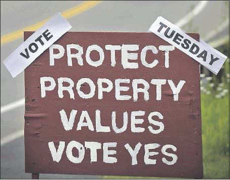 A political sign stands on Spring Street in Freeport on Monday in advance of Tuesday’s school election.