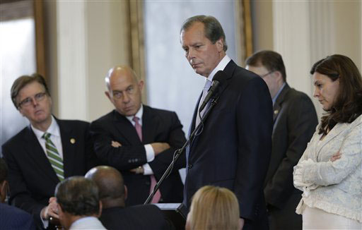 Texas Lt. Gov. David Dewhurst, center, conferences with senators over a point of order during Sen. Wendy David's filibuster of a bill limiting abortions on Tuesday.