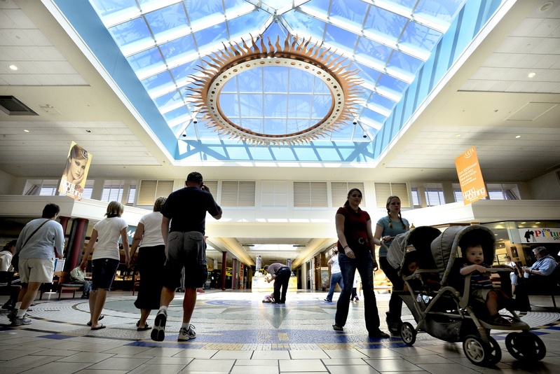 Shoppers crisscross the center atrium of The Maine Mall in South Portland. The mall has abandoned an appeal of its tax assessment.