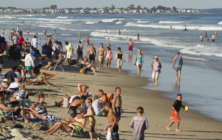 People congregate at Ogunquit Beach, one popular destination for tourists visiting Maine.