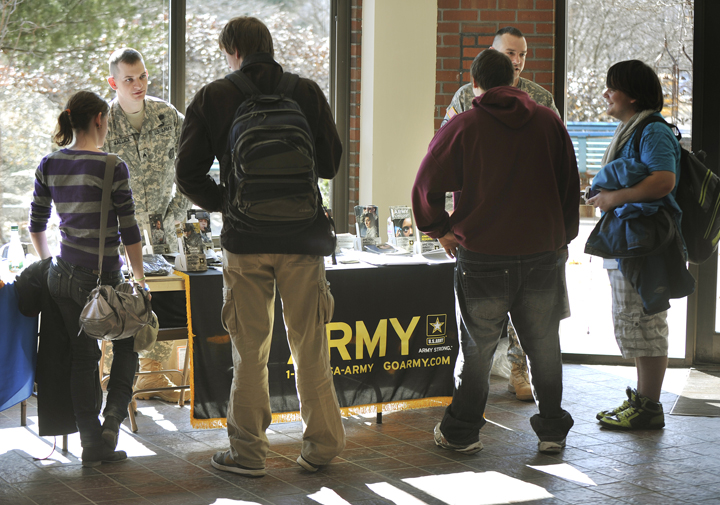 In this March 2012 file photo, U.S. Army recruiters Sgt. Stephen Wallace (left) and Sfc. Brandon Didier talk with students at the Portland Arts and Technology High School. Gov. Paul LePage’s claim that military recruiters aren’t allowed to wear their uniforms at Yarmouth High School is untrue, according to the principal of the school.