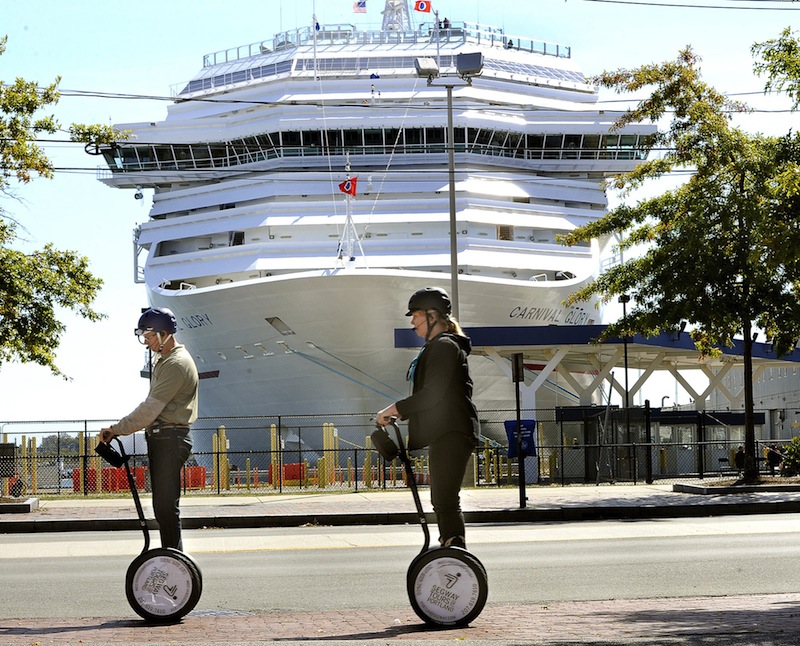 In this September 2012 file photo, a Segway tour passes in front of the Carnival Glory cruise ship in Portland. The city is seeing an increase in cruise-ship visitors in 2013.