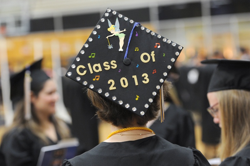 A graduate of the University of Southern Maine shows her status at commencement in May. A new report by Sallie Mae finds that the largest single source of college financing is grants and scholarships, supplanting parents' contributions. USM