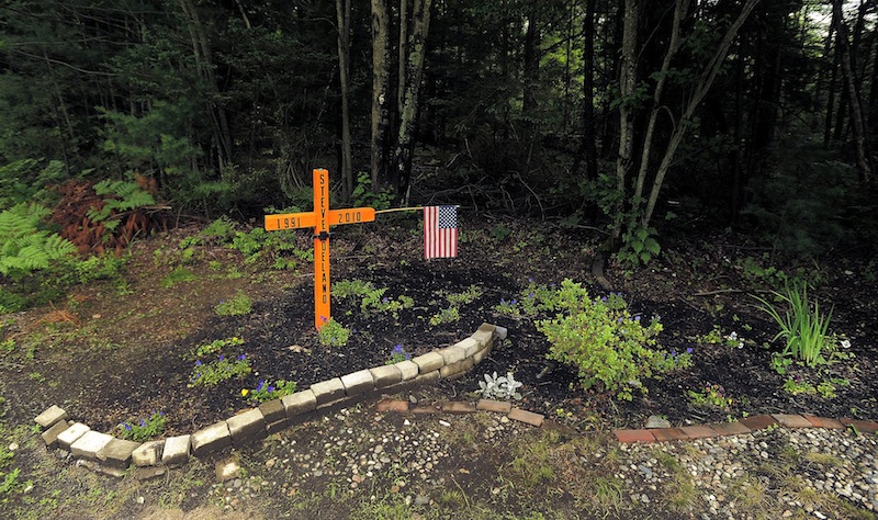 A roadside memorial for Steven Delano, seen Saturday, June 29, 2013, stands at the corner of Holmes and Payne Road in Scarborough where he was killed in a car crash in 2010.