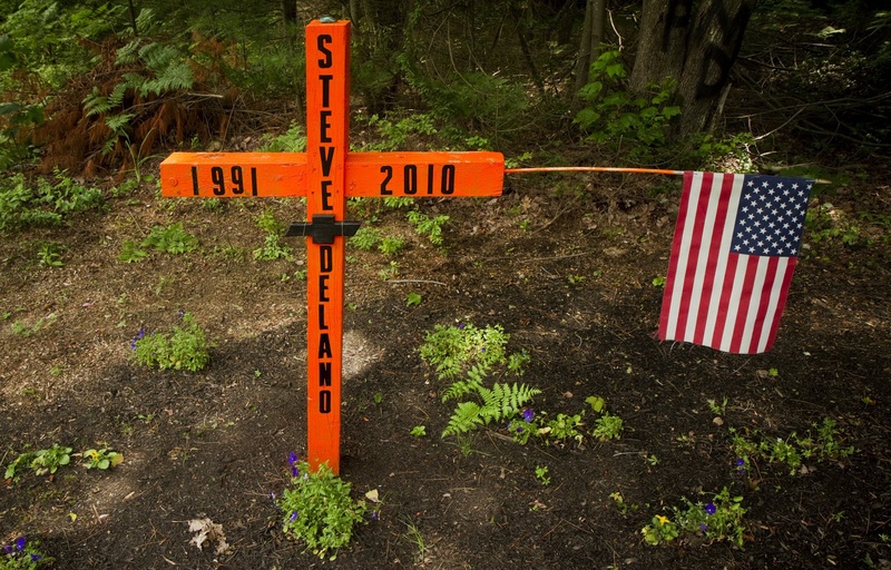 A roadside memorial occupies the location of a fatal accident on Payne Road in Scarborough. The Town Council has put off consideration of an ordinance to regulate such displays.