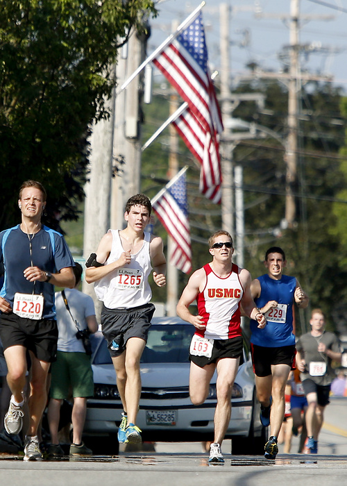 Competitors run up Main Street near the finish line during the L.L.Bean Fourth of July 10K Road Race in Freeport.