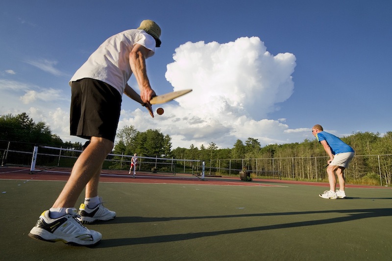 A pickleball player gets ready to serve while playing at Sunset Ridge Golf Course in Westbrook on Friday, July 5, 2013. Pickleball is a game similar to tennis, played with oversized ping pong paddles and a plastic ball like a whiffleball on a small tennis court with a 34-inch net.