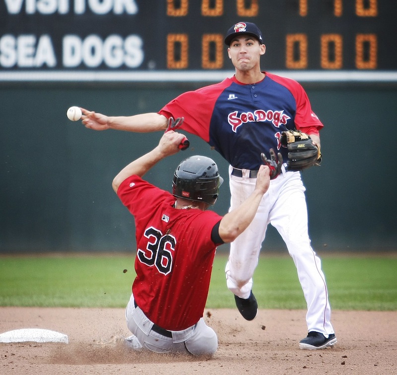 Portland Sea Dogs shortstop Derrik Gibson (15) forces out New Britain Rock Cat Josmil Pinto (36) at second base and makes the throw to first for a double play in the eighth inning at Hadlock Field in Portland on Monday, July 8, 2013.