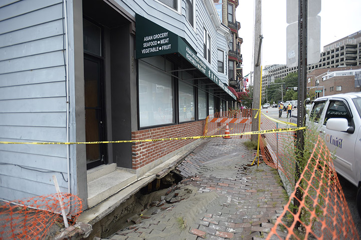 The sidewalk in front of the Hong Kong Market on Congress Street in Portland was closed after it was damaged by a water main break on Monday.