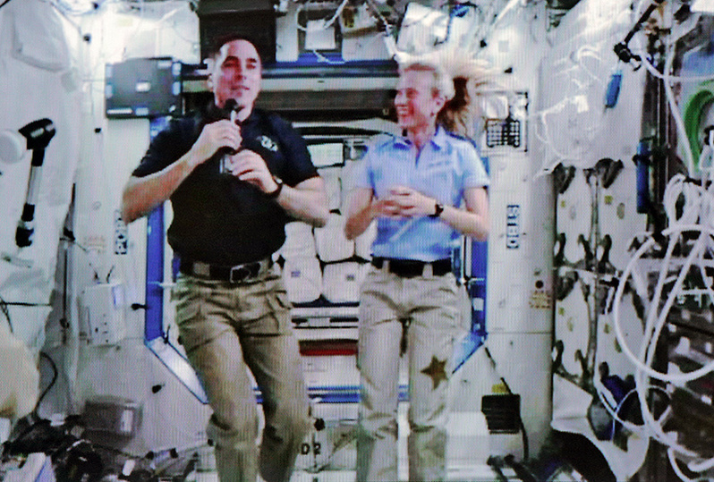 A video of astronauts Chris Cassidy, left, who is from Maine, and Karen Nyberg streams live from the Space Station via the NASA website as they participate in an interview with Press Herald Staff Writer Gillian Graham on Thursday.