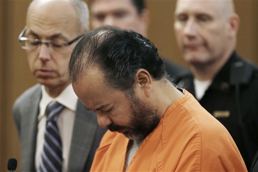 Ariel Castro stands before a judge during his arraignment Wednesday, June 12, 2013, in Cleveland. Castro, 52, is accused of holding three women captive in his Cleveland home for about a decade pleaded not guilty to hundreds of charges, including rape and kidnapping.