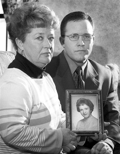 In this March 10, 2000, photo, Diane Dodd and son Casey Sherman hold a photo of Dodd's sister Mary Sullivan, who was found strangled in January 1964 and is believed to have been the last victim of the Boston Strangler.