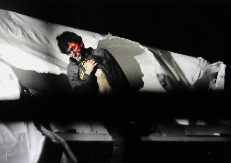 A Massachusetts State Police photo shows Boston Marathon bombing suspect Dzhokhar Tsarnaev, bloody and disheveled, with the red dot of a sniper’s rifle sight on his head, emerging from a boat in Watertown, Mass.