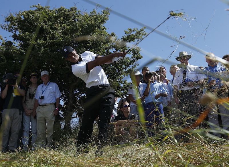 Tiger Woods of the United States plays out of the rough on the first fairway during the first round of the British Open Golf Championship at Muirfield, Scotland, on Thursday.