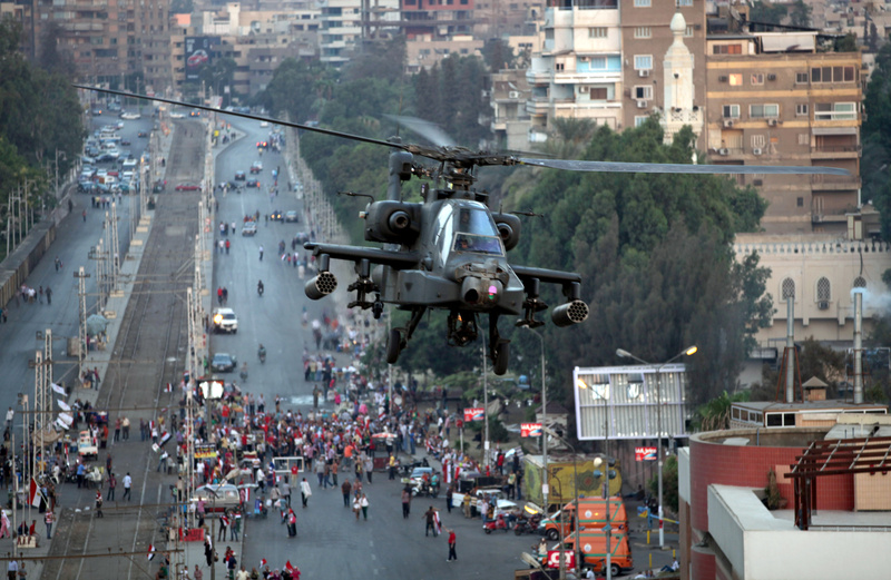 An Egyptian military attack helicopter flies over the presidential palace in Cairo, Egypt, on Friday.