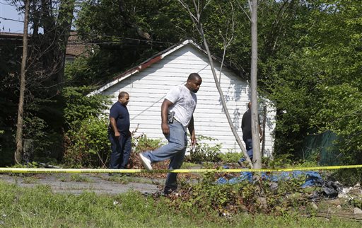 East Cleveland police search on Sunday near where three bodies were recently found, in East Cleveland, Ohio. The bodies, believed to be female, were found about 100 to 200 yards apart, and a 35-year-old man was arrested and is a suspect in all three deaths, East Cleveland Mayor Gary Norton said.