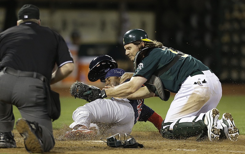 Boston Red Sox's Jackie Bradley Jr., center, is tagged out at home plate by Oakland Athletics catcher John Jaso in the ninth inning of a baseball game Friday, July 12, 2013, in Oakland, Calif. (AP Photo/Ben Margot)