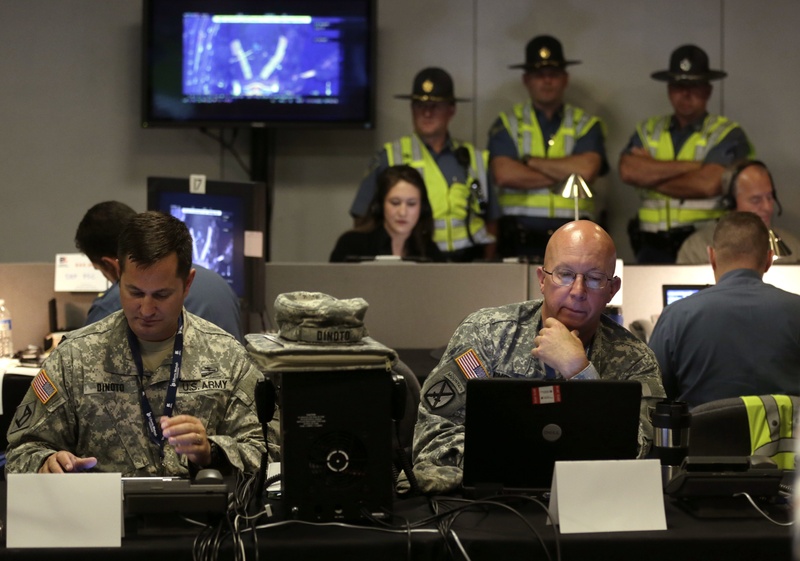 Law enforcement officials monitor surveillance cameras as part of an increased security effort for the Independence Day celebration, the first major public gathering since the Boston Marathon bombings, at the Unified Command Center on Wednesday in Boston.