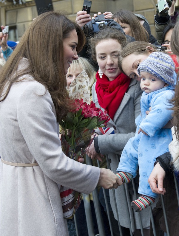 In this Wednesday Nov. 28, 2012 file photo Britain's Kate Duchess of Cambridge. left. meets with a young member of the public as she arrives at the Guildhall during a visit to Cambridge England. Prince William's wife Kate has been admitted to the hospital in early stages of labor it was announced on Monday July 22, 2013. (AP Photo/Arthur Edwards, File)