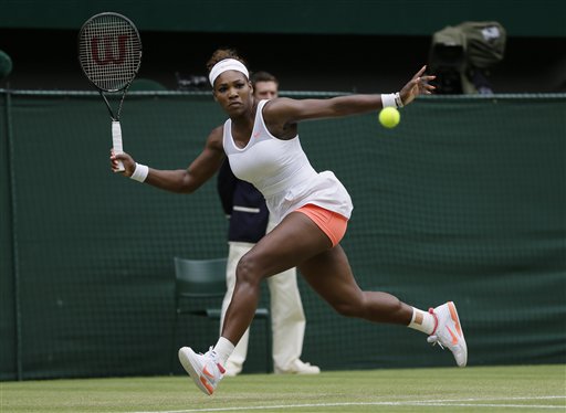 Serena Williams returns to Sabine Lisicki of Germany during a women's singles match at Wimbledon on Monday. (AP Photo/Alastair Grant)