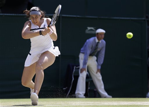 Marion Bartoli of France plays a return to Sabine Lisicki of Germany during their Women's singles final match at the All England Lawn Tennis Championships in Wimbledon, London, Saturday.
