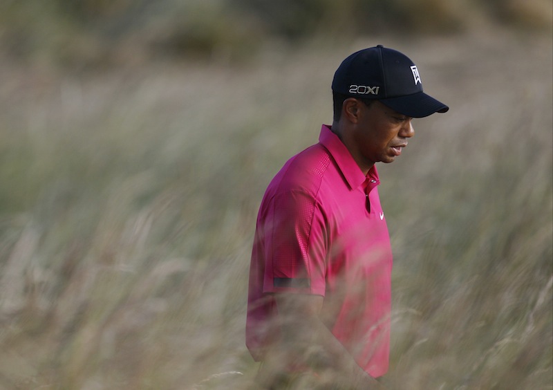 Tiger Woods of the US walks to the 4th fairway during a practice round for the British Open Golf Championship at Muirfield, Scotland, Tuesday July 16, 2013. (AP Photo/Alastair Grant)