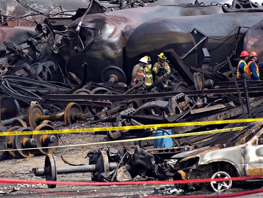Crews move through the debris on Tuesday as cleanup work continues at the crash site of the train derailment and fire in Lac-Megantic, Quebec.