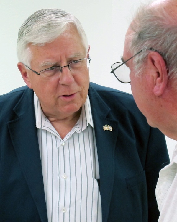 This July 2, 2013 photo shows U.S. Sen. Mike Enzi, R-Wyo., talks to constituent John Marquardt at a senior center in Pine Bluffs, Wyo. Enzi, on the left, hasn't said yet whether he will seek re-election to the Senate while Liz Cheney, daughter of former Vice President Dick Cheney, has said she's prepared to challenge him in the 2014 Republican primary. (AP Photo/Ben Neary)