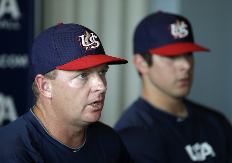USA manager Jim Schlossnagle speaks during a news conference as pitcher Carlos Rodon, right, looks on, Wednesday, July 17, 2013, in Des Moines, Iowa. The Cuban national team and a squad made up of American college stars will square off in a five-game, three-city series starting Thursday in Des Moines. (AP Photo/Charlie Neibergall)