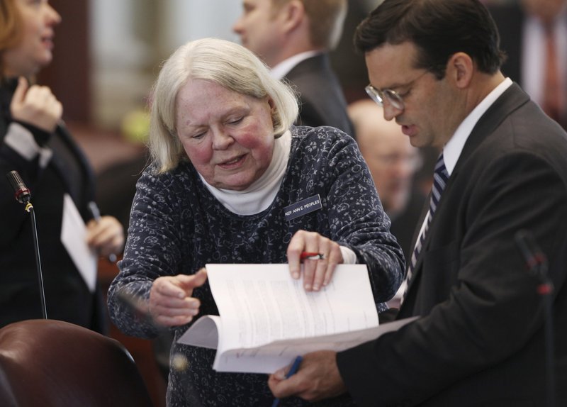 Rep. Ann Peoples, D-Westbrook, left, speaks with then House Majority Leader Seth Berry, D-Bowdoinham, right, in 2013 at the State House in Augusta. 