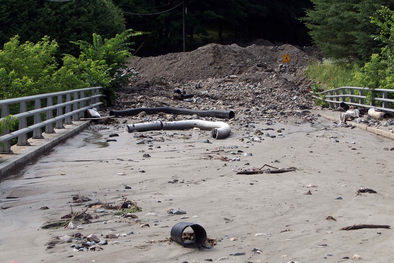 Debris from a mudslide covers a road in Lebanon, N.H., Wednesday after heavy rains caused flash flooding in the area.