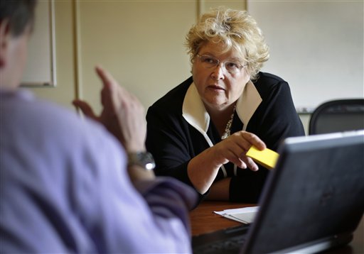Christine Ferguson, director of the Rhode Island health insurance exchange, takes part in a meeting at the Statehouse in Providence, R.I. The Rhode Island marketplace will postpone a feature that allows consumers to enter the names of their doctors and instantly find out what insurance plans they accept.