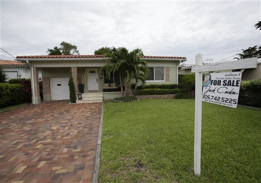 A single-family home is shown for sale in Surfside, Fla., recently. Higher home prices make homeowners feel wealthier, encouraging consumers to spend more.