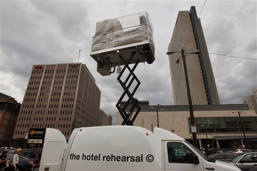 A hotel room made of aluminum and inflated vinyl is held aloft by a van-mounted scissor lift, on promotional display in a parking lot in downtown Denver on July 25, 2013.