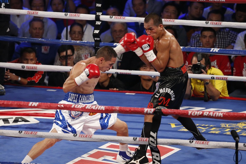 Mexico's Juan Francisco Estrada, left, fights against Milan Melindo of the Philippines during their WBO/WBA Flyweight Title match at the Cotai Arena in Venetian Macao in Macau Saturday July 27, 2013. A Chinese fighter’s victory at a Macau showdown brings the world’s top casino market a step closer to challenging Las Vegas for dominance of another Sin City staple: big-time boxing matches. Macau, which long ago eclipsed Vegas as the world's top gambling city, is now looking to add to its allure by holding the kind of boxing bouts that Las Vegas is known for. (AP Photo/Dennis Ho)