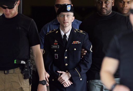 In this July 30, 2013 photo, Army Pfc. Bradley Manning is escorted out of a courthouse in Fort Meade, Md.