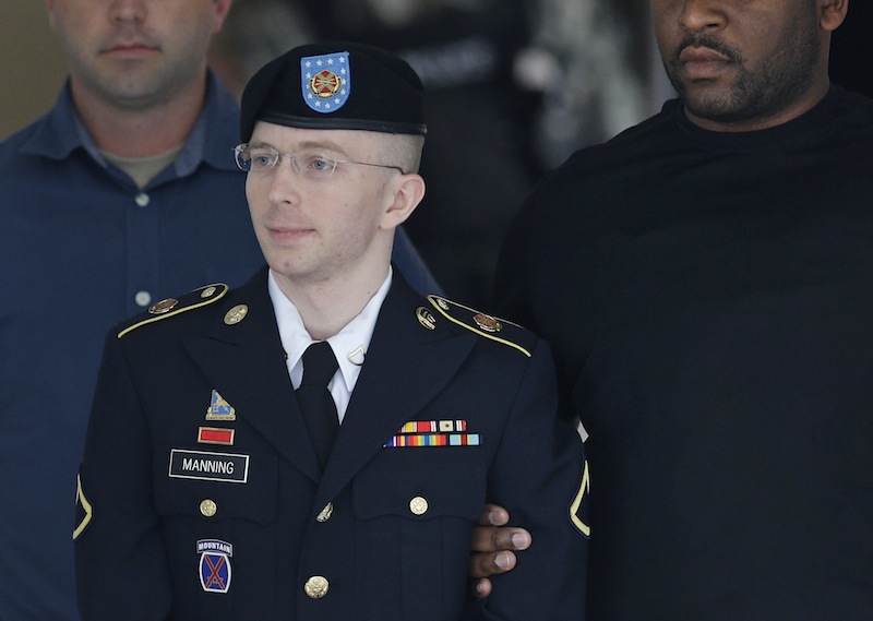 Army Pfc. Bradley Manning is escorted out of a courthouse in Fort Meade, Md., Tuesday, July 30, 2013, after receiving a verdict in his court martial. Manning was acquitted of aiding the enemy — the most serious charge he faced — but was convicted of espionage, theft and other charges, more than three years after he spilled secrets to WikiLeaks. (AP Photo/Patrick Semansky)
