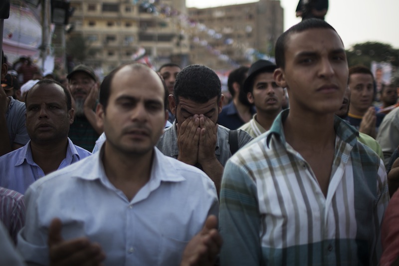 Supporters of the ousted Egypt's President Mohammed Morsi pray during a protest in Nasr City, a suburb of Cairo, Egypt, Tuesday July 9, 2013. After days of deadlock, Egypt's military-backed interim president named a veteran economist as prime minister on Tuesday and appointed pro-democracy leader Mohamed ElBaradei as a vice president, while the army showed its strong hand in shepherding the process, warning political factions against “maneuvering” that impedes the transition. (AP Photo/Manu Brabo)