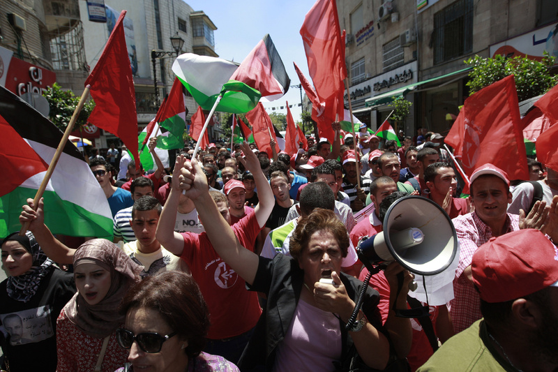 Palestinians protest Sunday in the West Bank city of Ramallah against resuming peace talks with Israel.