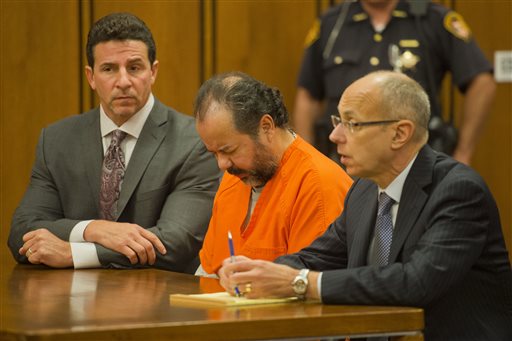 Ariel Castro, center, enters the court before a judge with his defense attorney's, Craig Weintraub, left, and Jaye Schlachet during a pretrial hearing on Wednesday, June 19, 2013, in Cleveland. A tentative Aug. 4 trial date has been set for Castro, accused of kidnapping three women and holding them in his home for about a decade.