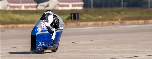 Bill Warner makes a run on his motorcycle during The Maine Event on a runway at a former air base Sunday, July 14 2013, at Limestone, Maine. Warner, 44, of Wimauma, Fla., died Sunday after losing control and zooming off a runway on a later run.