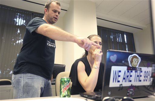 IInformation technology professional Josh Scott, left, helps a computer user who did not want to be identified during a monthly "Cryptoparty" in Dallas.