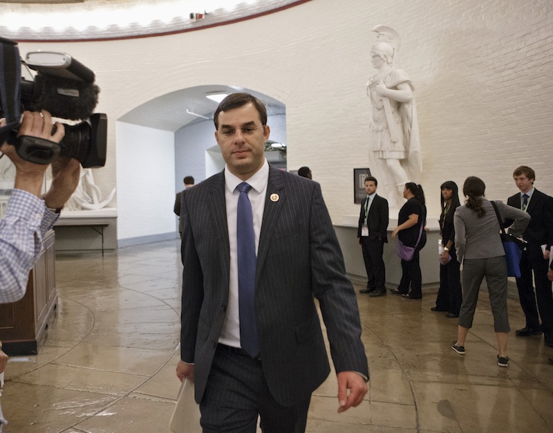 Rep. Justin Amash, R-Mich., walks through a basement corridor to the House of Representatives for the vote on his amendment to the Defense spending bill that would cut funding to the National Security Agency's phone surveillance program, on Capitol Hill, Wednesday. The measure was narrowly rejected.